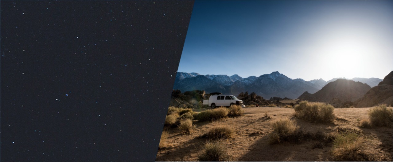 Camper van in the middle of the desert surrounded by mountains